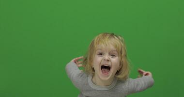 Kid girl on a Green Screen, Chroma Key. Happy three years old girl video