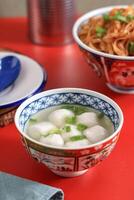 Singapore Fish ball Soup, Clear Soup Broth with White Chewy Fishball photo