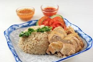 Hainanese Chicken Rice or Rice Steamed with Chicken photo