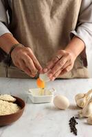 Woman Crack Egg to the Bowl photo