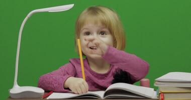 Girl drawing at the table. Education process in classroom. Chroma Key video