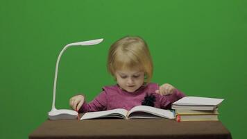 Girl drawing at the table. Education process in classroom. Chroma Key video