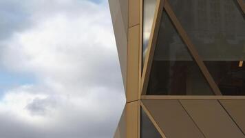 Top view of architecture of modern windows of building with reflection. Stock footage. Reflection of sky in windows of modern office building. Stylish architecture of modern building with reflection photo