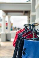 a row of clothes hanging on a rack photo