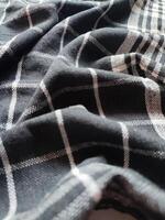 Close-up of black white checkered napkin or picnic tablecloth texture, kitchen accessories. photo