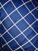 Close-up of blue and white checkered napkin or picnic tablecloth texture, kitchen accessories. photo