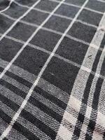 Close-up of black white checkered napkin or picnic tablecloth texture, kitchen accessories. photo