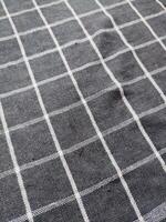 Close-up of black white checkered napkin or picnic tablecloth texture, kitchen accessories. photo