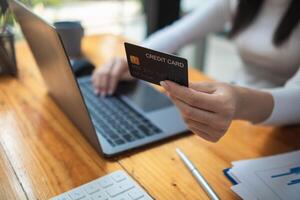 business woman is using credit card to pay for products online when ordering products from store through an online website because using credit card to pay for products brings convenience in shopping photo