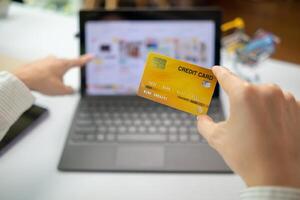 business woman is using credit card to pay for products online when ordering products from store through an online website because using credit card to pay for products brings convenience in shopping photo