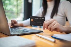 business woman is using credit card to pay for products online when ordering products from store through an online website because using credit card to pay for products brings convenience in shopping photo