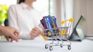 Credit card are popularly used today era because they are convenient for purchasing products from regular stores and online stores can purchase products through application by paying with credit card. photo