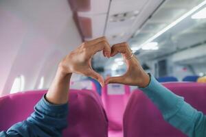 lover raises her hands and makes heart symbol express meaning of love friendship and kindness towards her friend and lover. couple uses their hands to make heart symbol that means love and friendship. photo