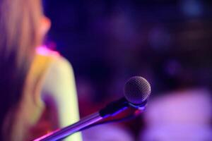 A silver vintage-style microphone is housed in the practice room to prepare singers to practice vocals through a quality microphone and record vocals to keep listening to improve their singing. photo