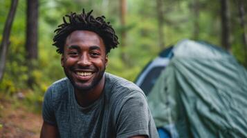 AI generated Portrait of smiling man with backpack standing in front of camping tent photo