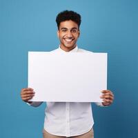 AI generated smiling young businessman holding blank sheet of paper, over blue background photo