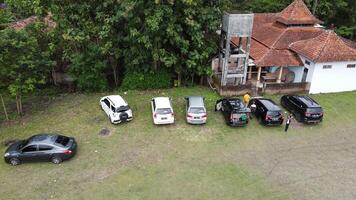 Aerial photo of a line of cars in a field in Mindi, Klaten, Central Java, Indonesia.