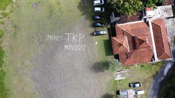 Aerial photo of a line of cars in a field in Mindi, Klaten, Central Java, Indonesia.