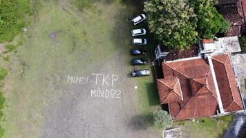 Aerial photo of a line of cars in a field in Mindi, Klaten, Central Java, Indonesia.