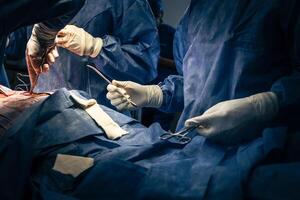 Hands of surgeons and surgical assistants with surgical supplies. photo