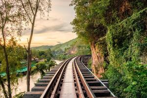 Ancient wooden railway historic of world war II at sunset photo