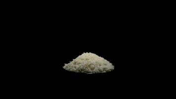 Mountain of basmati grains rice turning on black background video