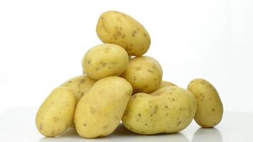 Mountain of potatoes fresh turning on white background video