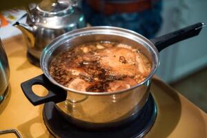 Pork stewed gravy in stainless pot. Asian food photo