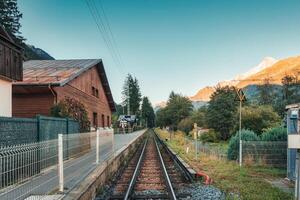 Wooden chalet by the railway in Lac des Gaillands among the French Alps photo