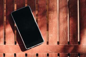 Smartphone blank display put on wooden table photo