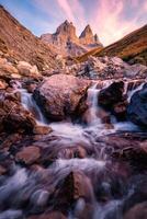 Aiguilles d'Arves with iconic mountain and waterfall flowing in French Alps photo