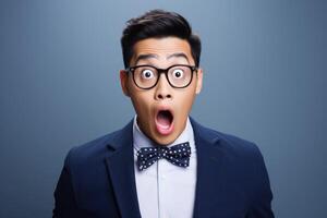 AI generated Young man with asian features dressed in suit is shocked, solid background photo