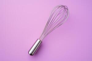 AI generated Metal whisk on color background, top view photo