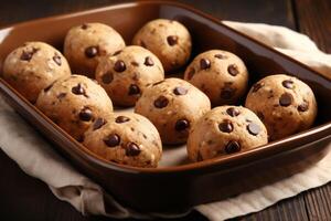 AI generated Baking pan with raw chocolate chip cookie balls on table, closeup photo