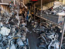 freight container filled with used car parts on junkyard shop photo