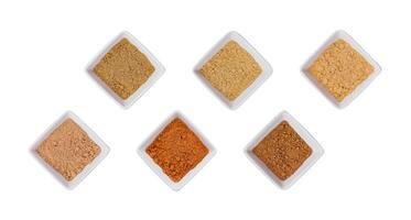 Various Indian Spices in Small White Bowls on white background photo