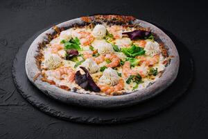 black pizza with shrimp and cream photo