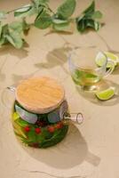 glass jug of green tea and lime photo