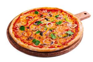 Delicious hot vegetable pizza on wood photo