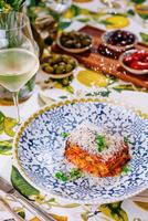 lasagna with and glass of white wine photo