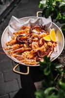 Grilled seafood plate with lemon photo