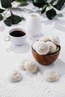 candies in white glaze and coconut flakes photo