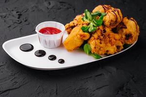 Traditional battered fried fish on plate photo