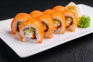 Sushi roll philadelphia with salmon and caviar on plate photo