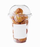 profiteroles with powdered sugar in plastic cup photo