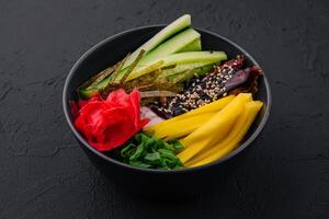 bowl with mango, cucumber and eel in unagi sauce photo