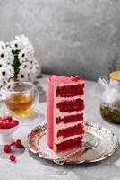 piece of delicious red velvet cake with tasty cream photo
