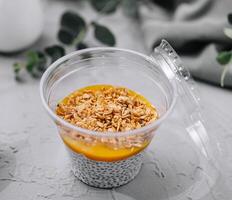 Chia pudding with mango and granola top view photo