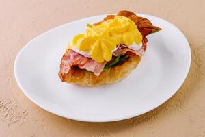 Croissant sandwich with bacon, cheese and egg photo