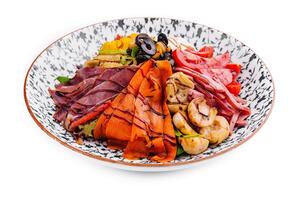 salad of various meats with mushrooms, carrots and lettuce leaves photo